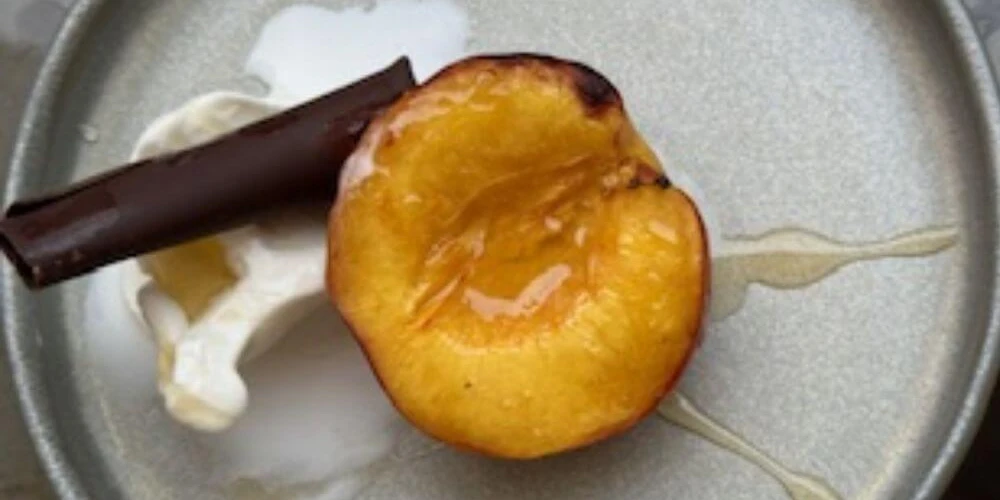 HONEY GRILLED PEACH TOPPED WITH VANILLA GELATO
